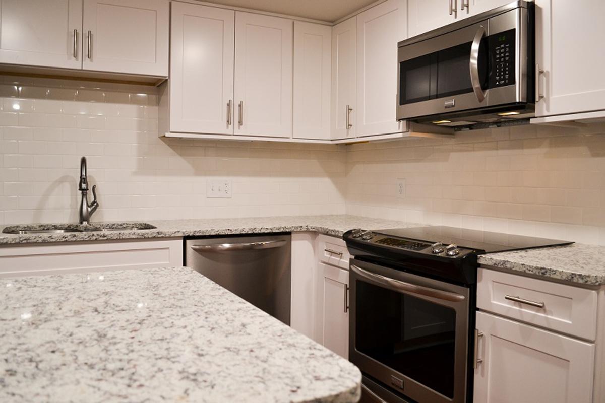 a white stove top oven sitting inside of a kitchen