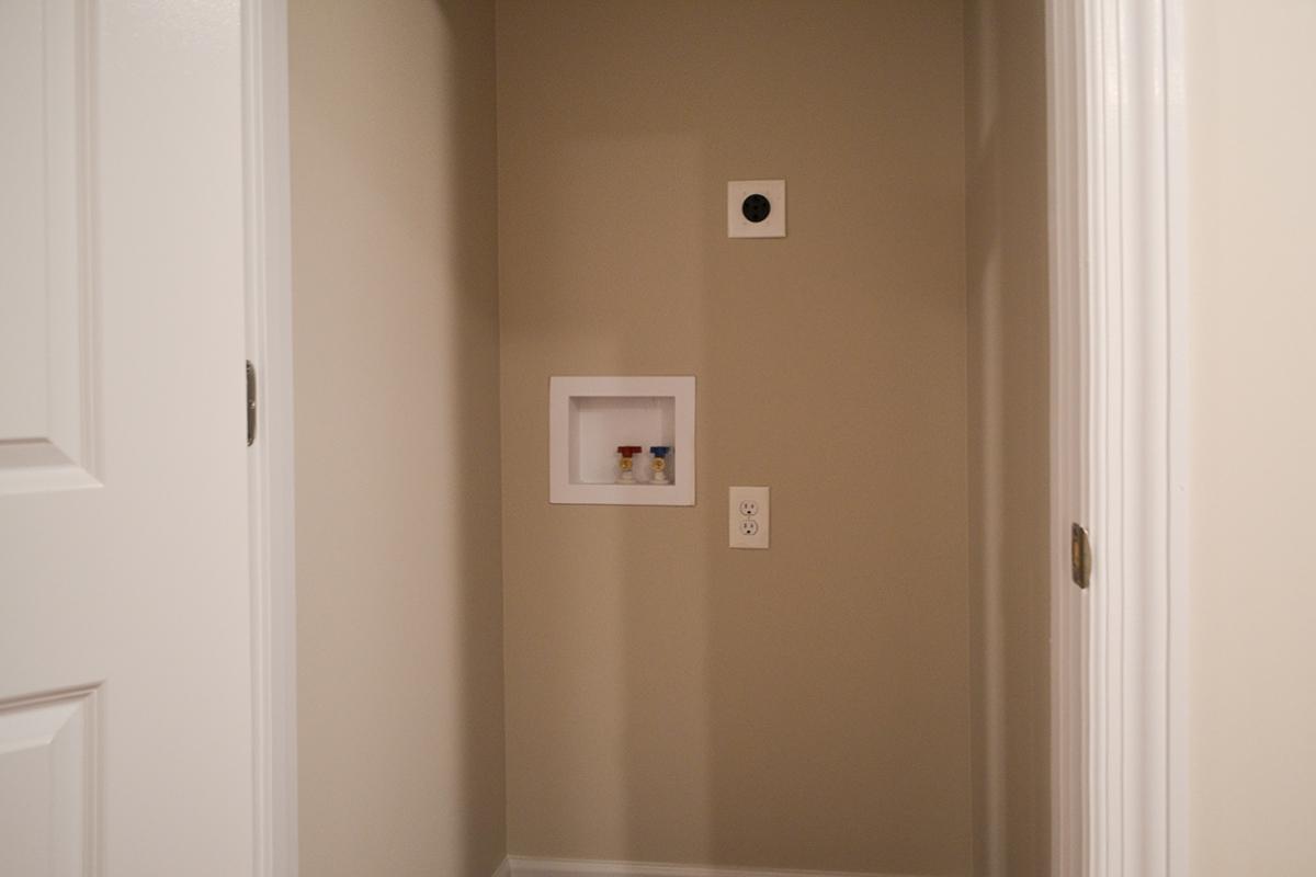 a white sink sitting next to a door