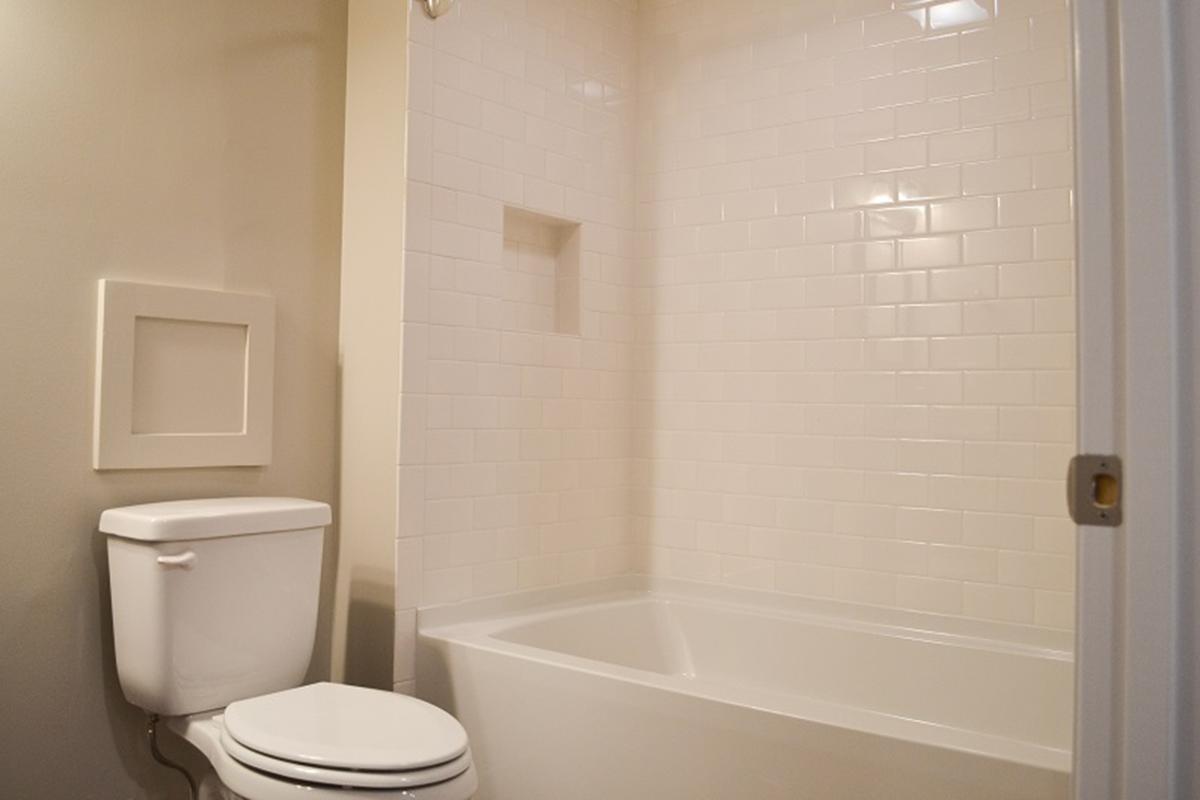 a white tub sitting next to a shower