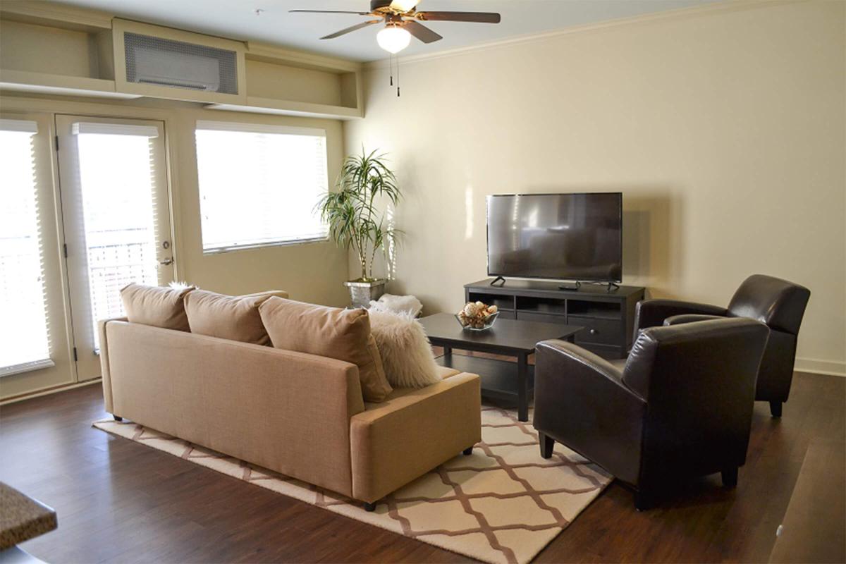a living room filled with furniture and a large window