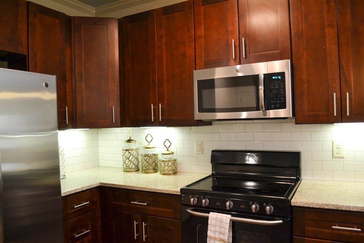 a kitchen with stainless steel appliances and wooden cabinets