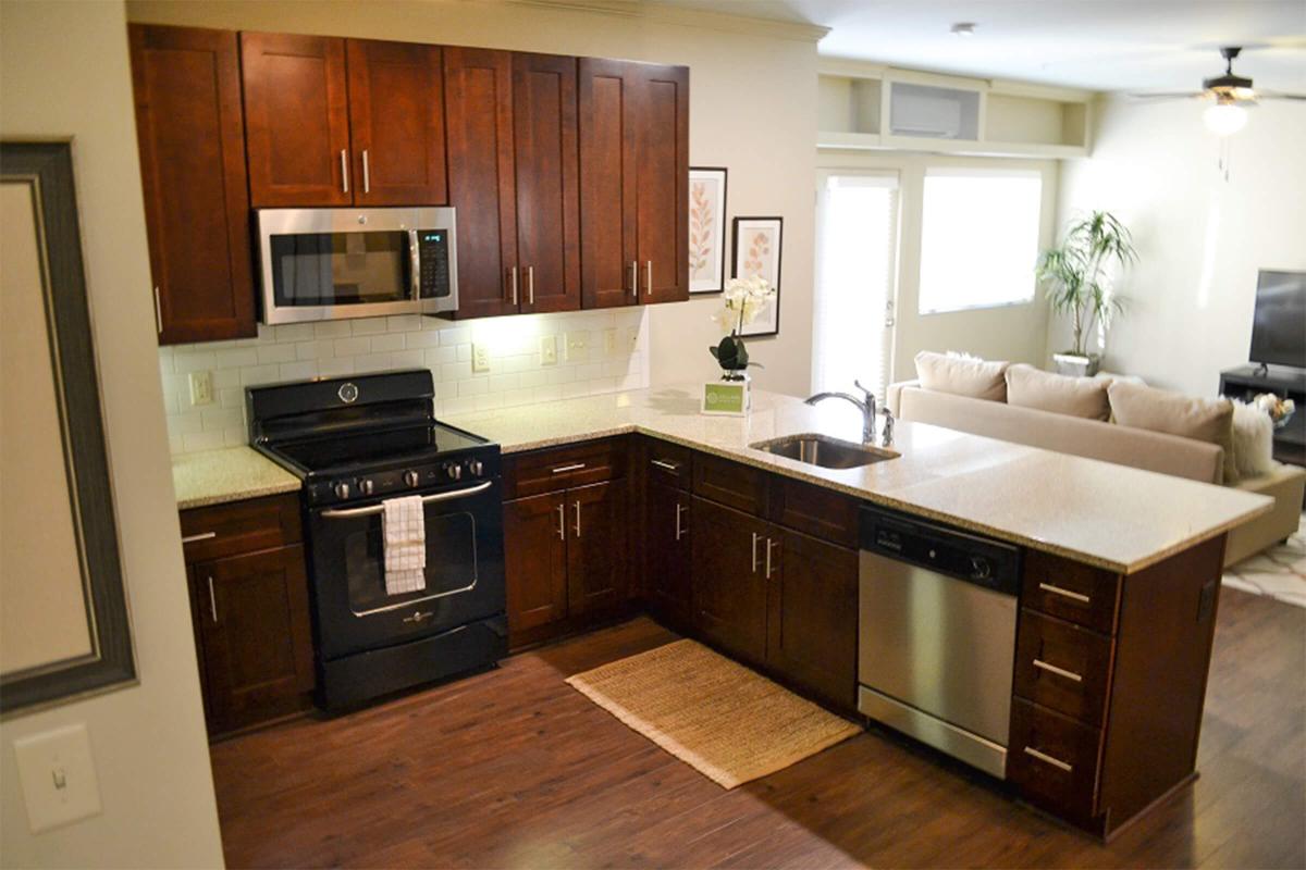 a modern kitchen with stainless steel appliances and wooden cabinets