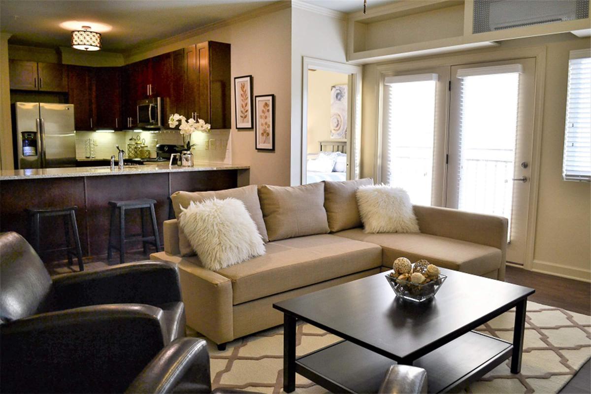 a living room filled with furniture and a large window