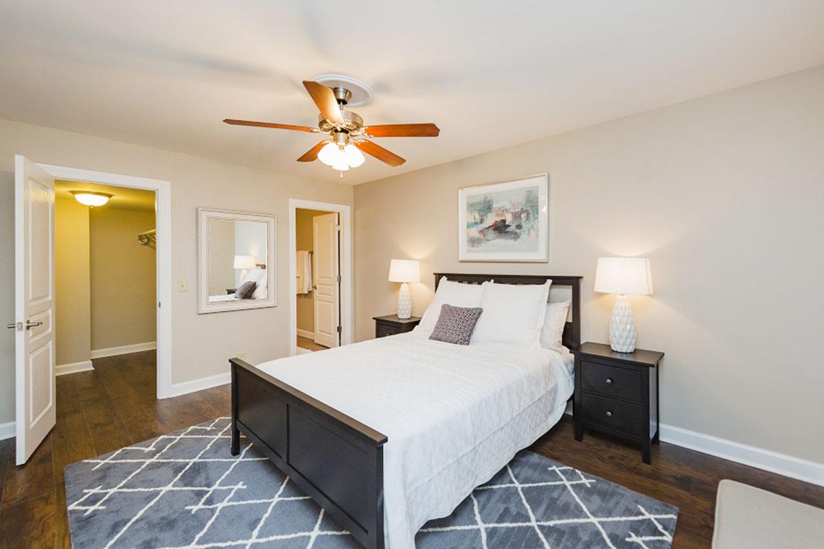 a bedroom with a bed and desk in a room
