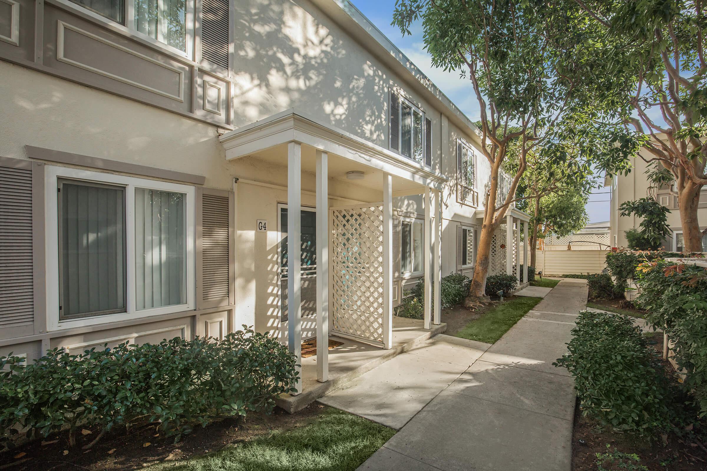 Sandpointe Cove Apartment Homes community building with green shrubs