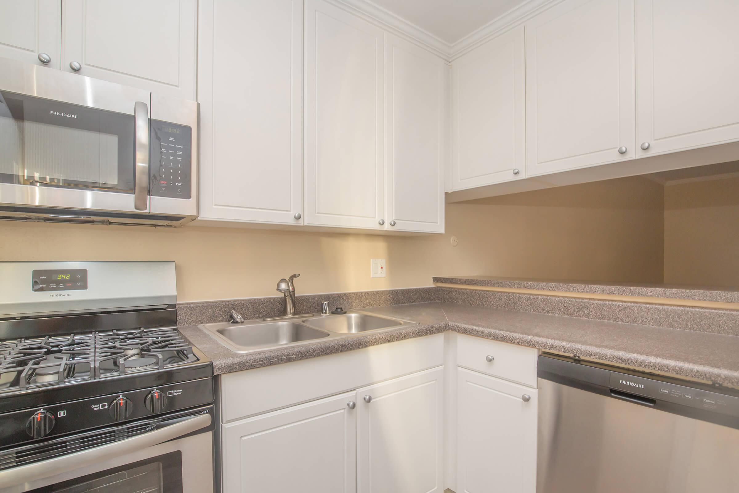 Kitchen with gas stove, dishwasher, microwave, and sink