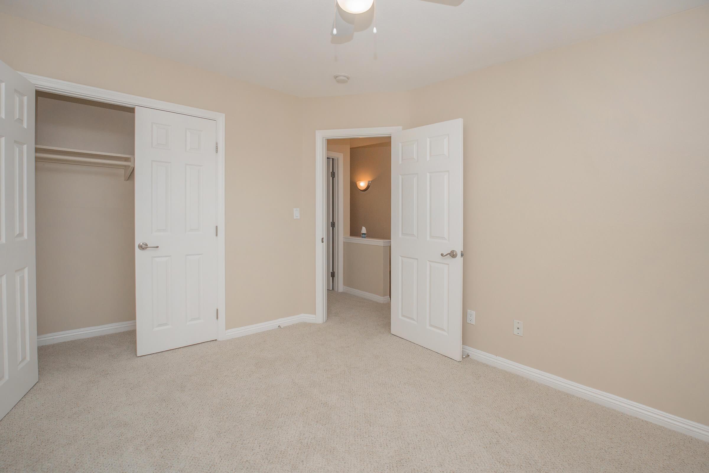 Vacant bedroom with carpet