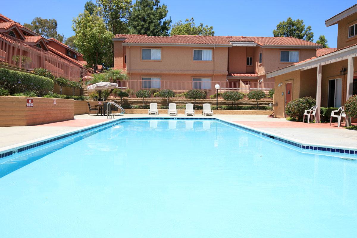 a house with a pool outside of a building