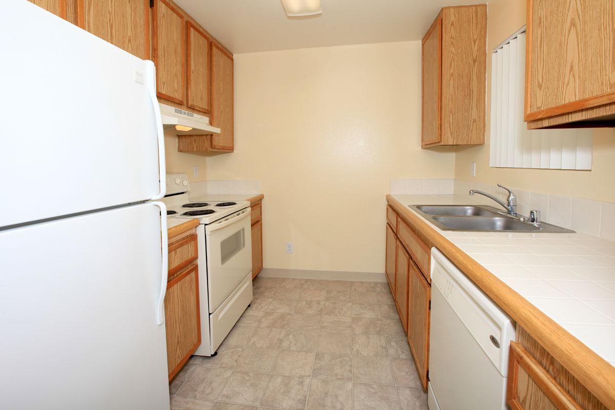 a white refrigerator freezer sitting inside of a kitchen