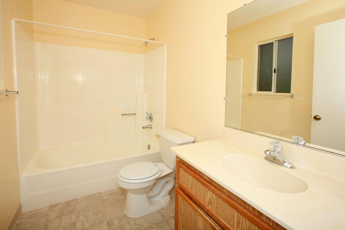 a large white tub sitting next to a sink