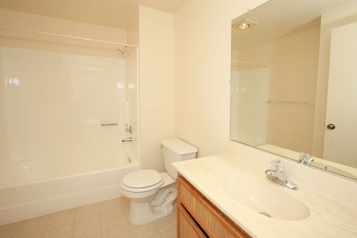 a white tub sitting next to a sink