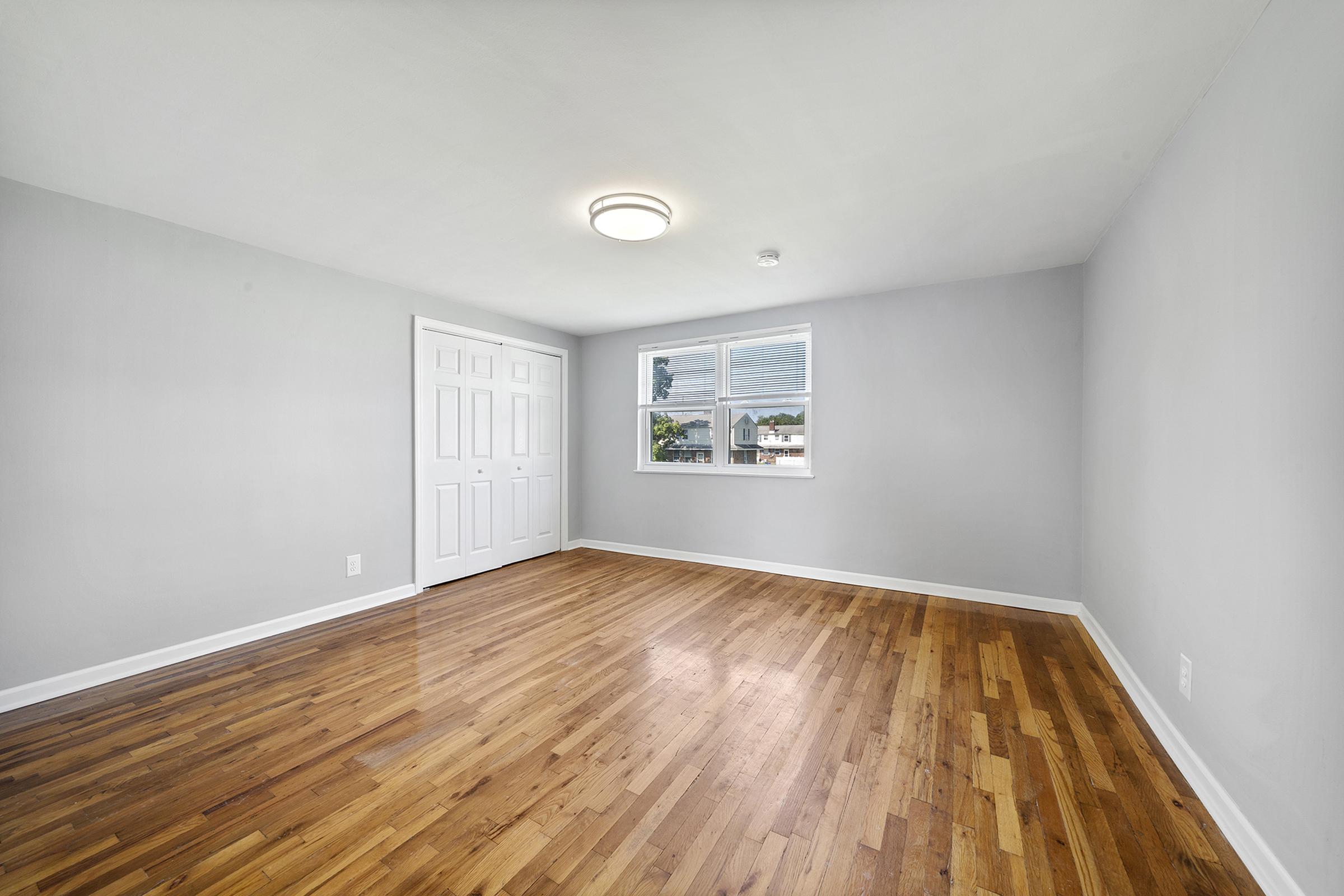 a large empty room with a wooden floor