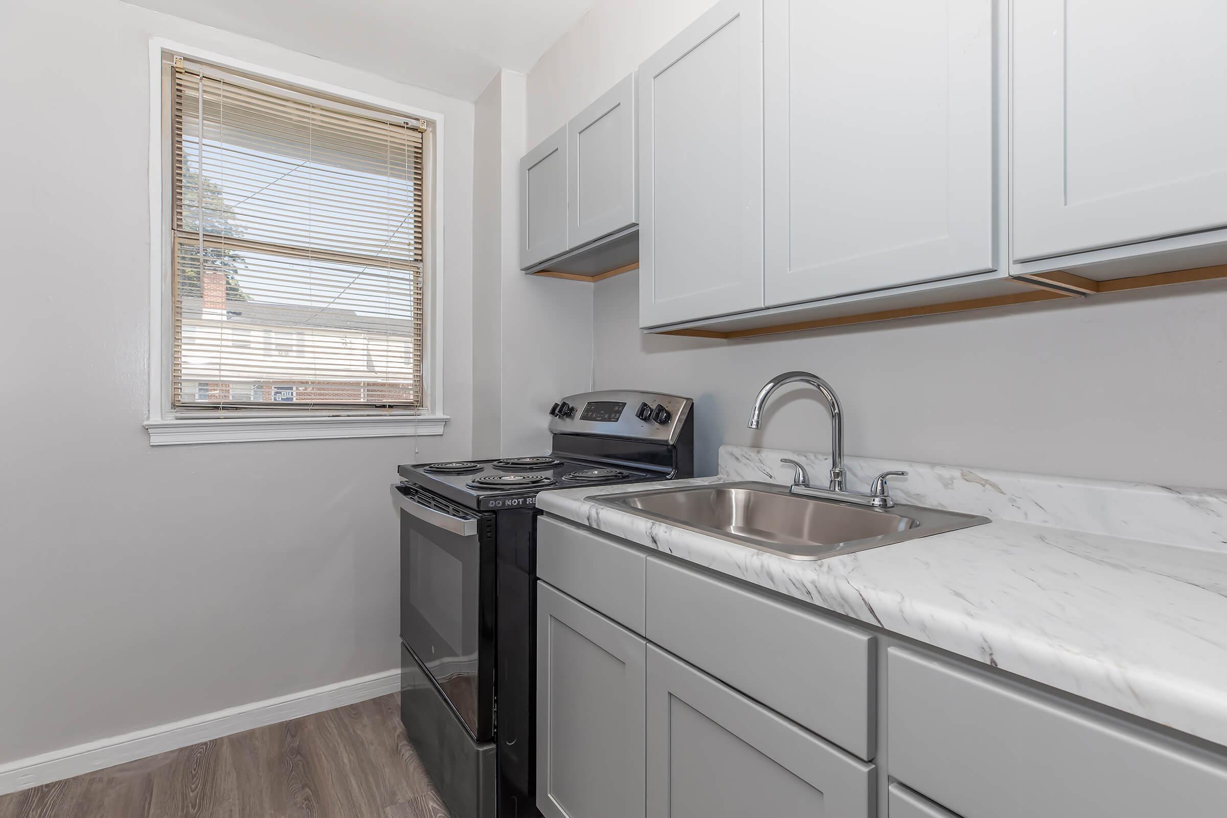 a kitchen with a sink and a window