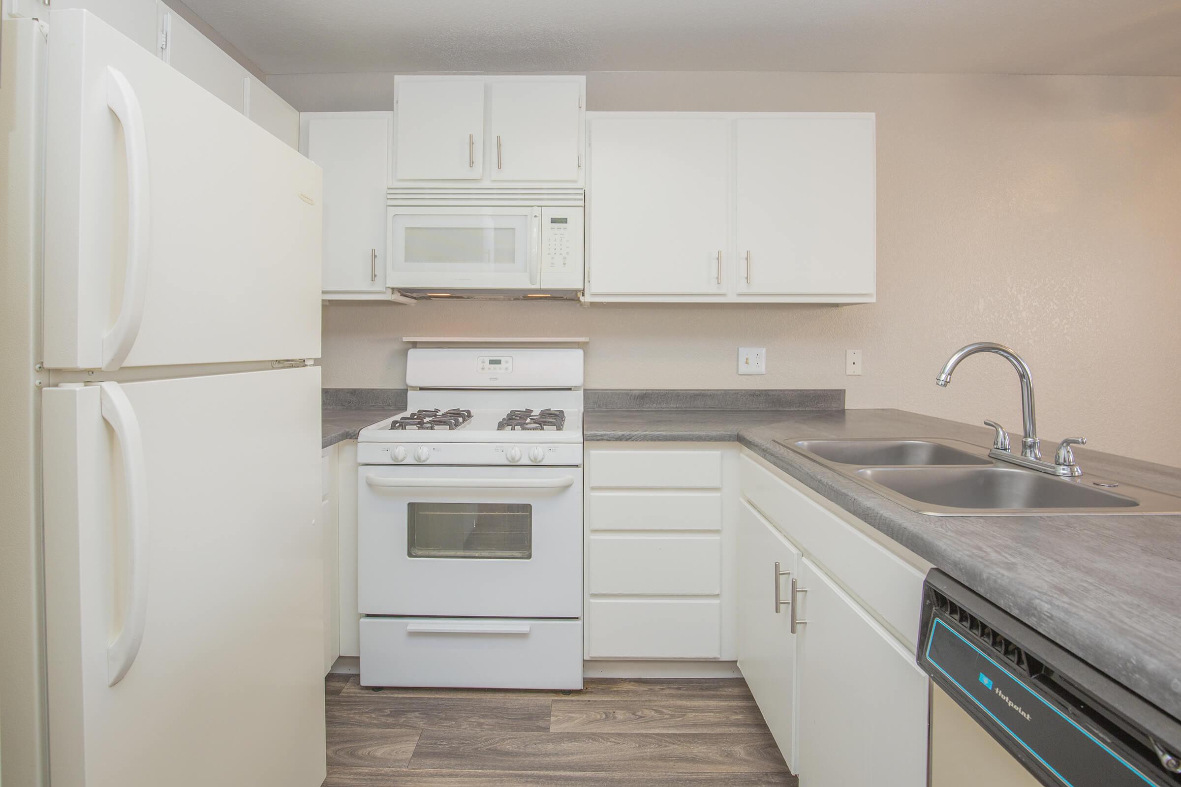 a white stove top oven sitting inside of a kitchen