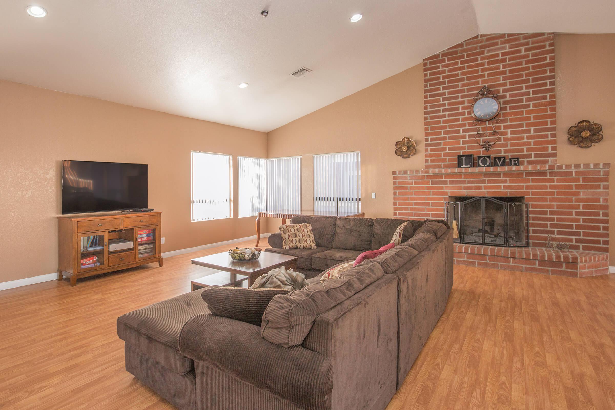 a living room filled with furniture and a fireplace