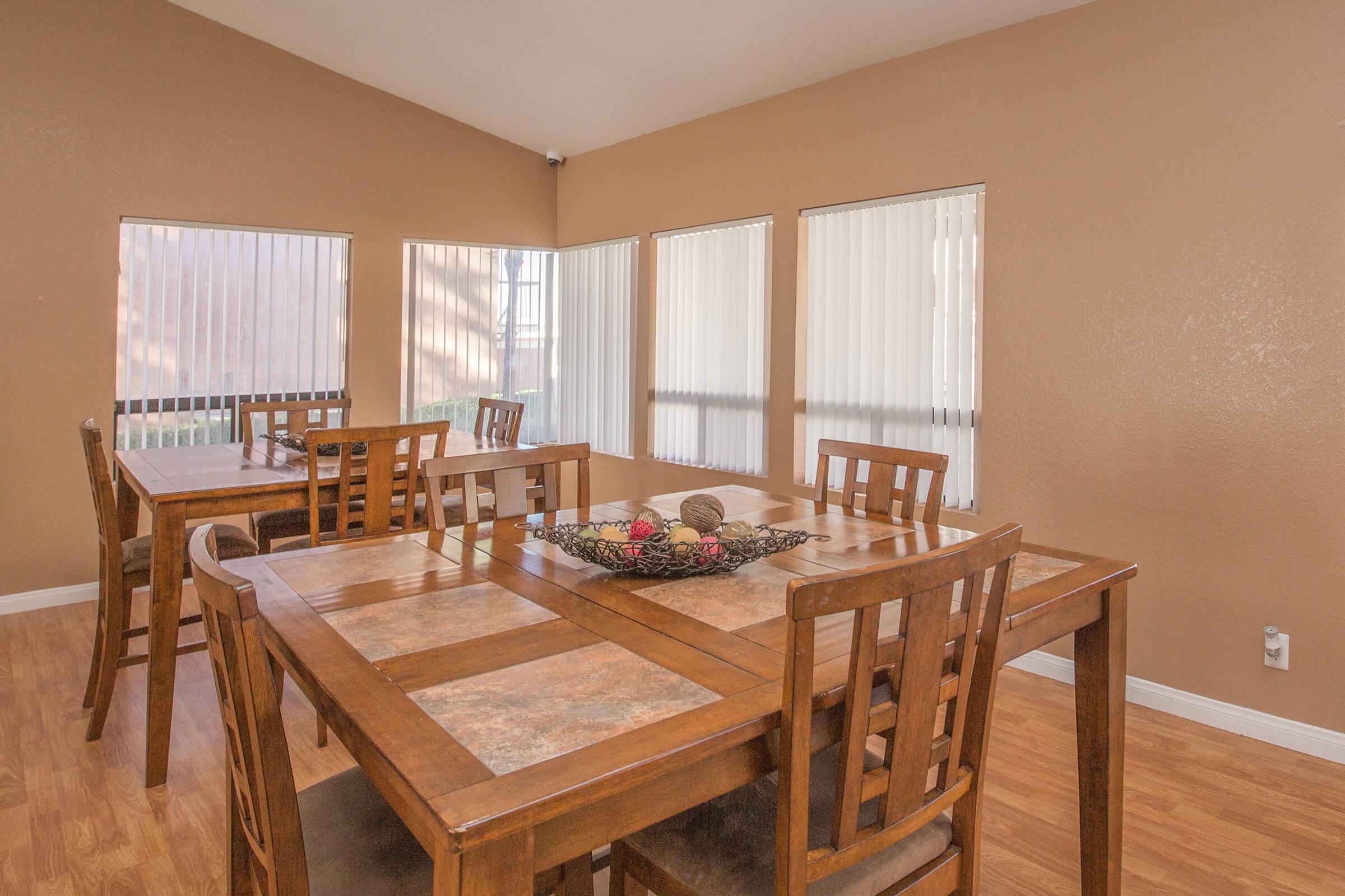 a dining room table in front of a window