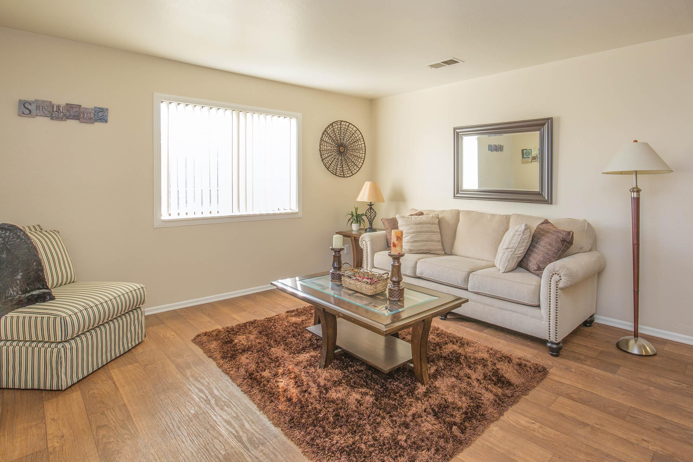 a living room filled with furniture and a flat screen tv