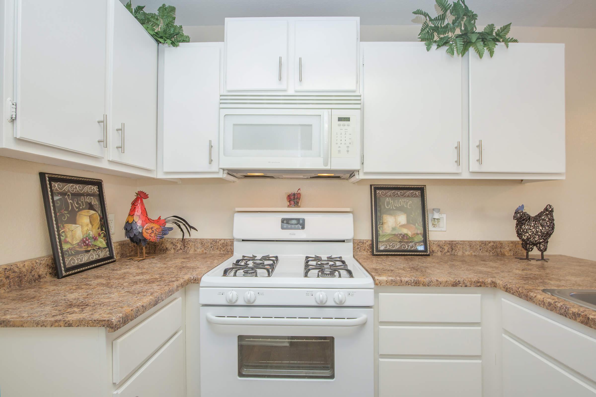 a white stove top oven sitting inside of a kitchen