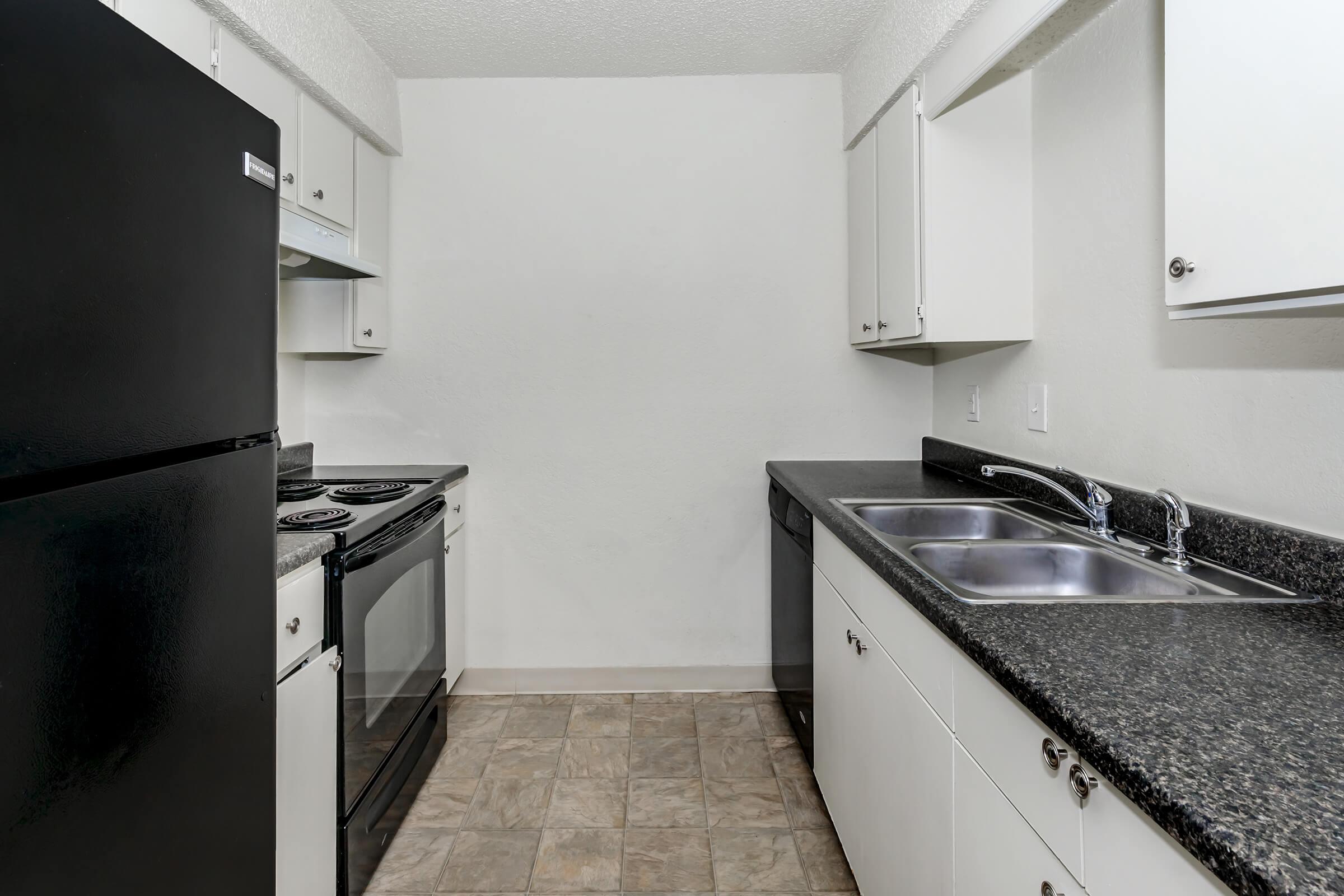 a kitchen with a stove sink and refrigerator