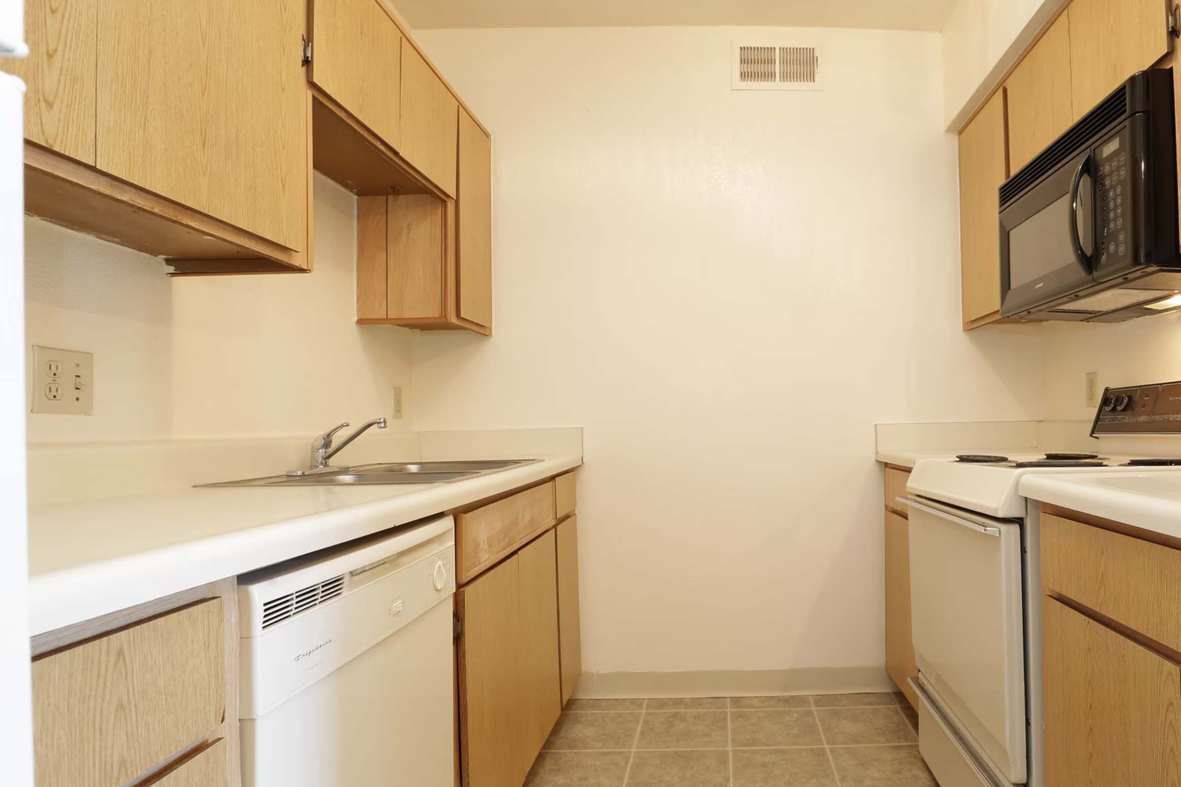 a kitchen with a stove sink and refrigerator