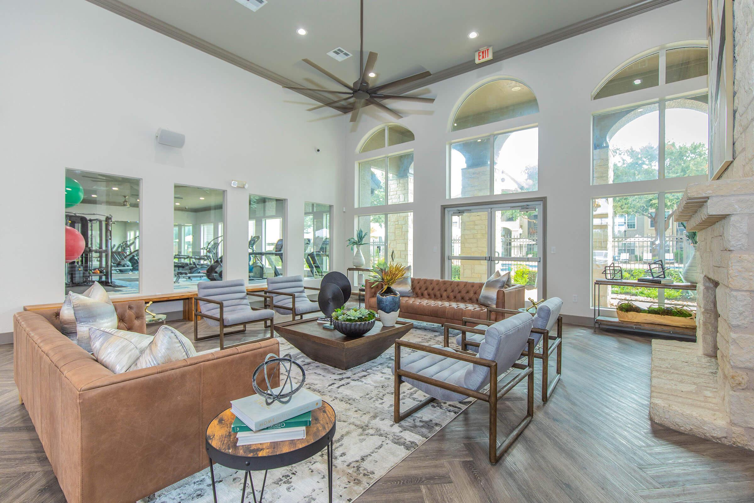 a living room filled with furniture and a large window