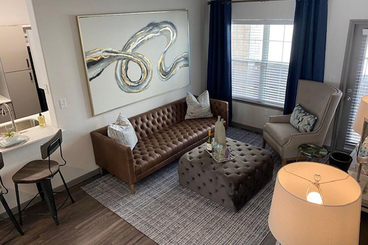 a living room filled with furniture and a large window