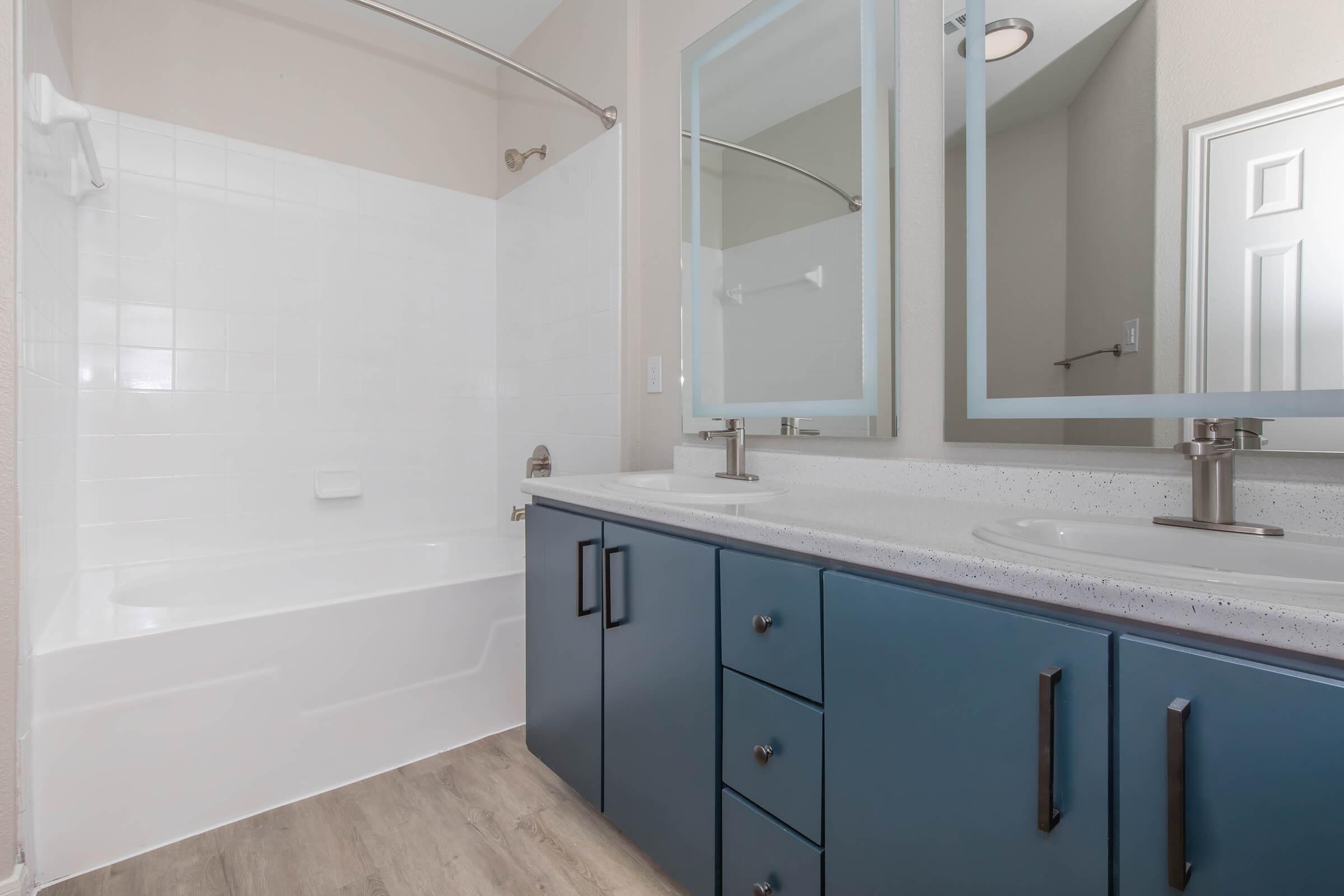 a kitchen with a sink and a mirror