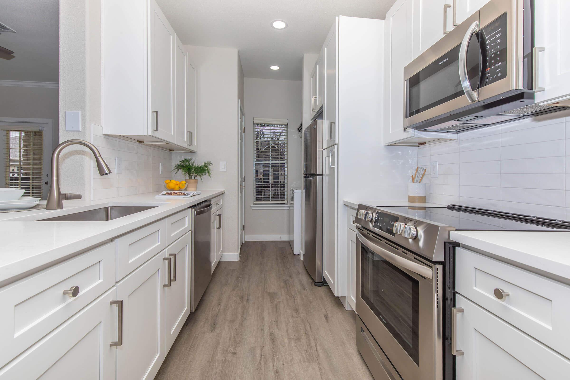 a kitchen with a sink and a refrigerator