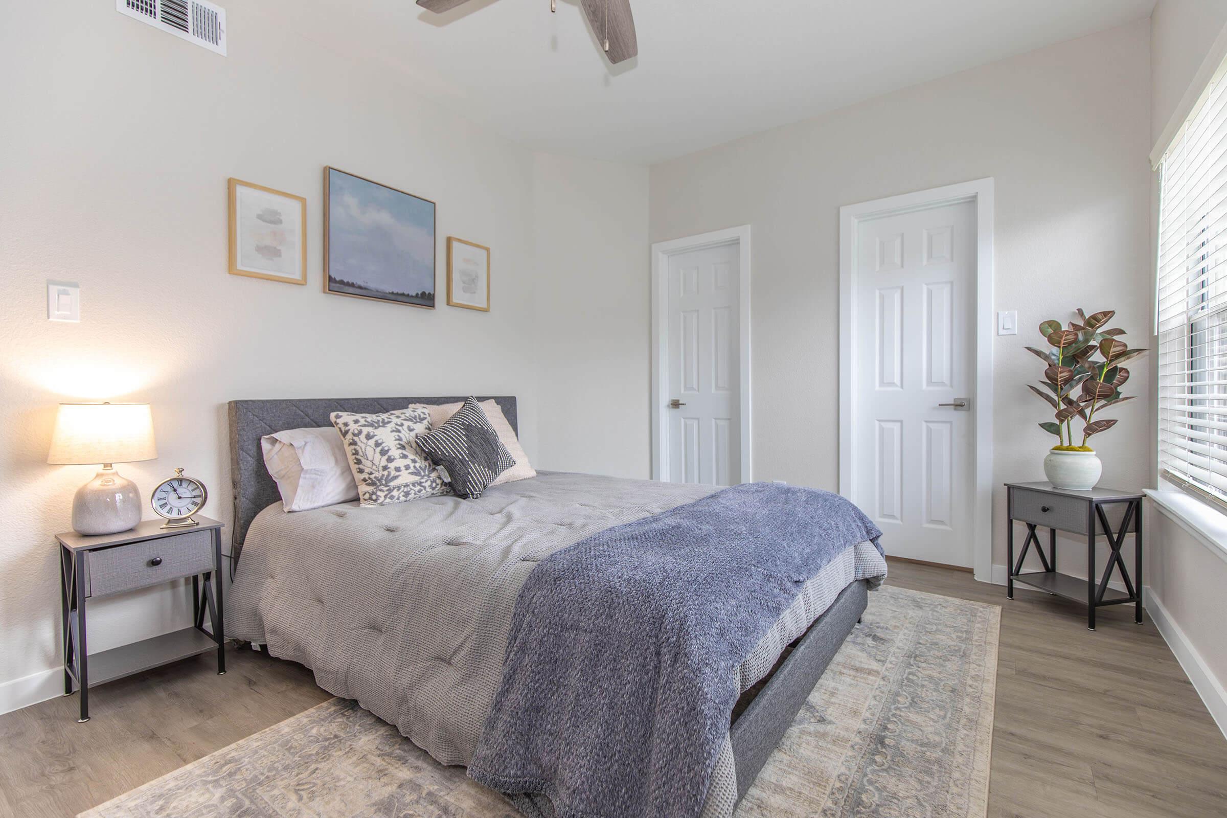 a bedroom with a bed and desk in a room