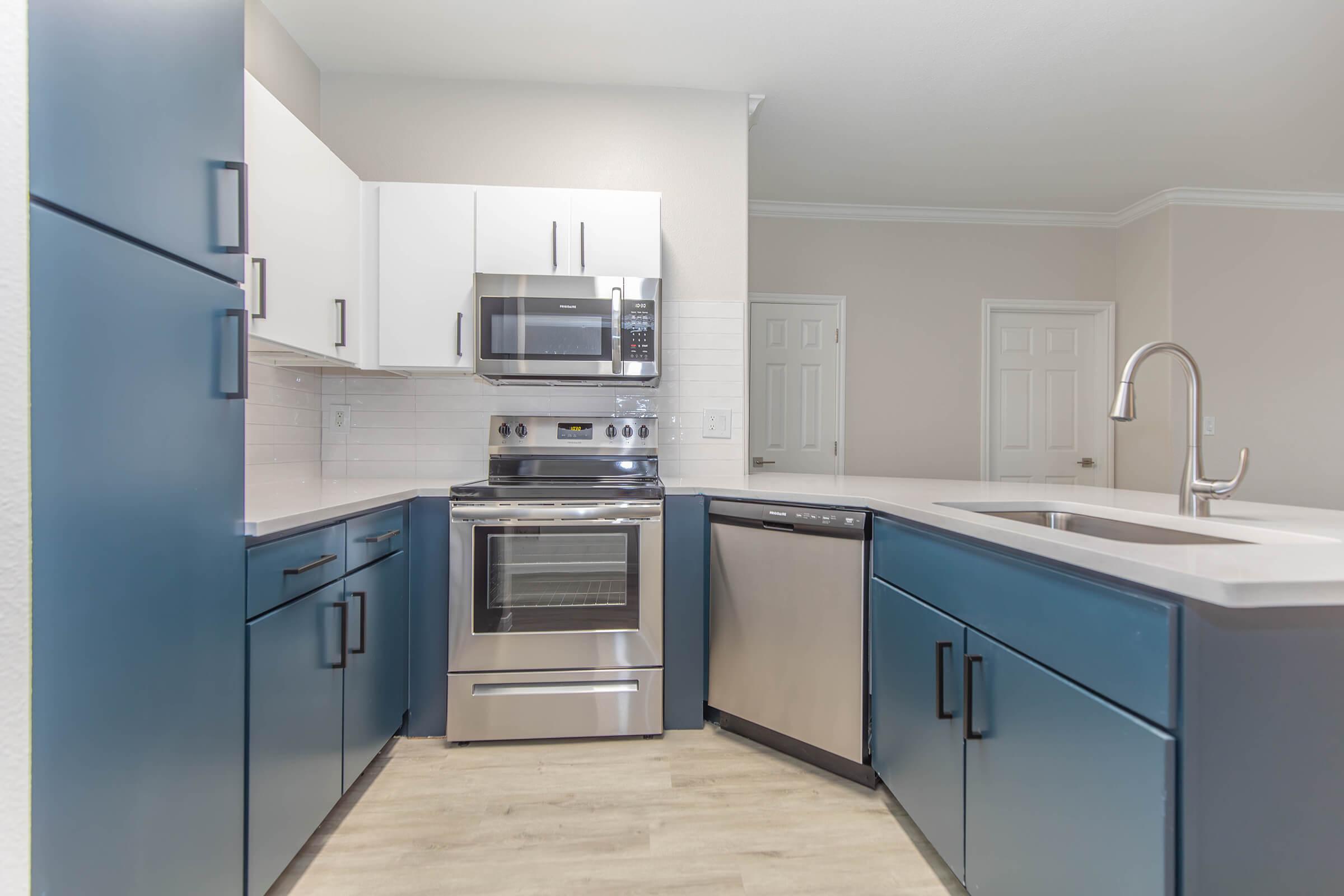 a kitchen with a stove sink and refrigerator