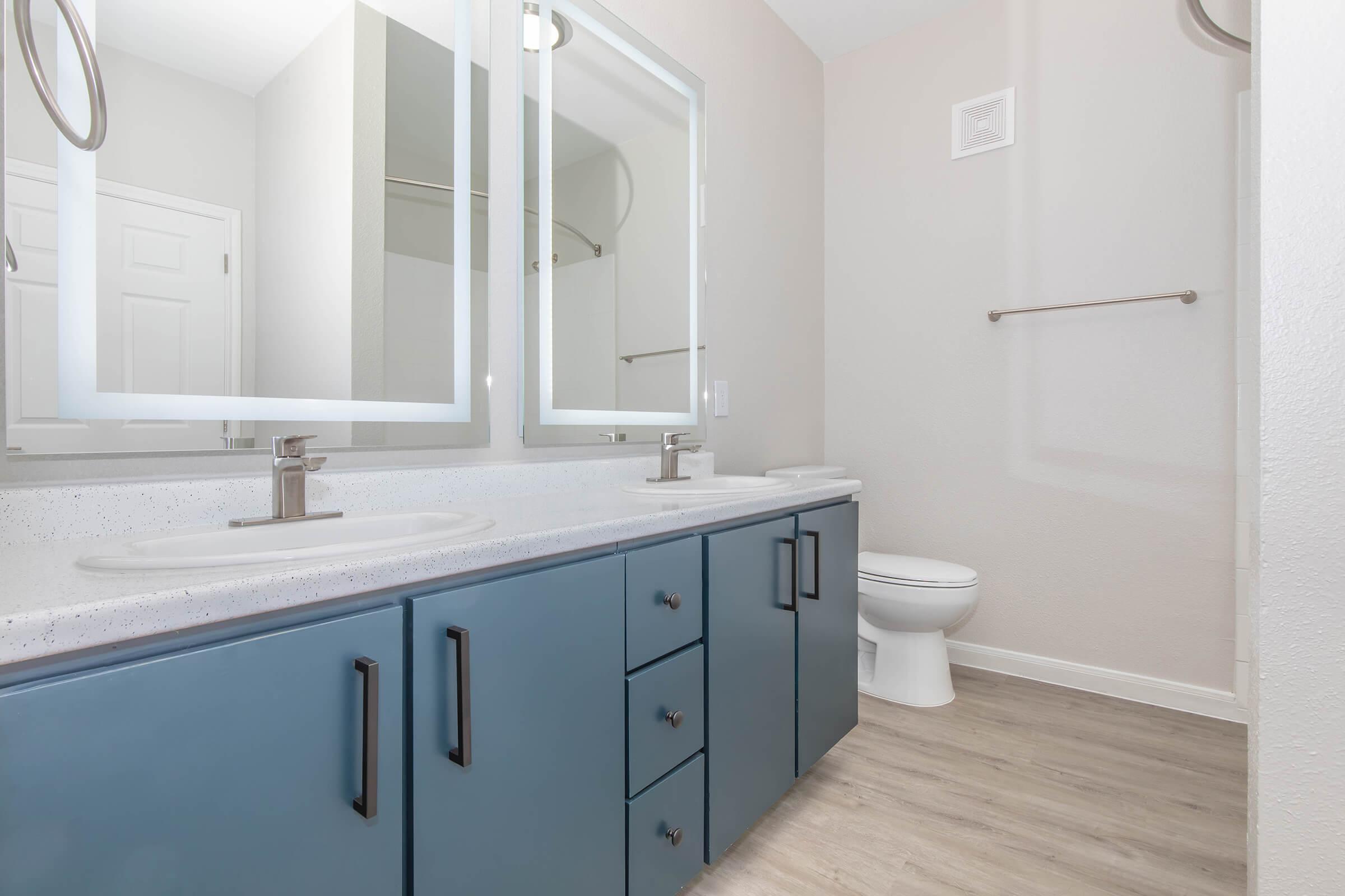 a kitchen with a sink and a mirror