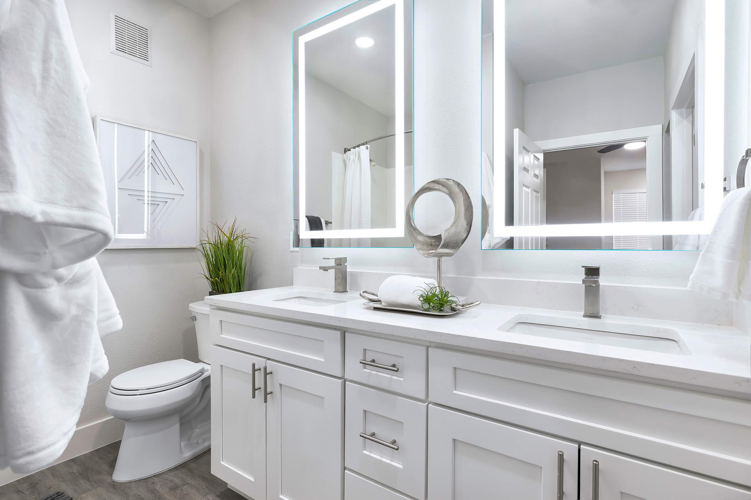 bathroom with white cabinets