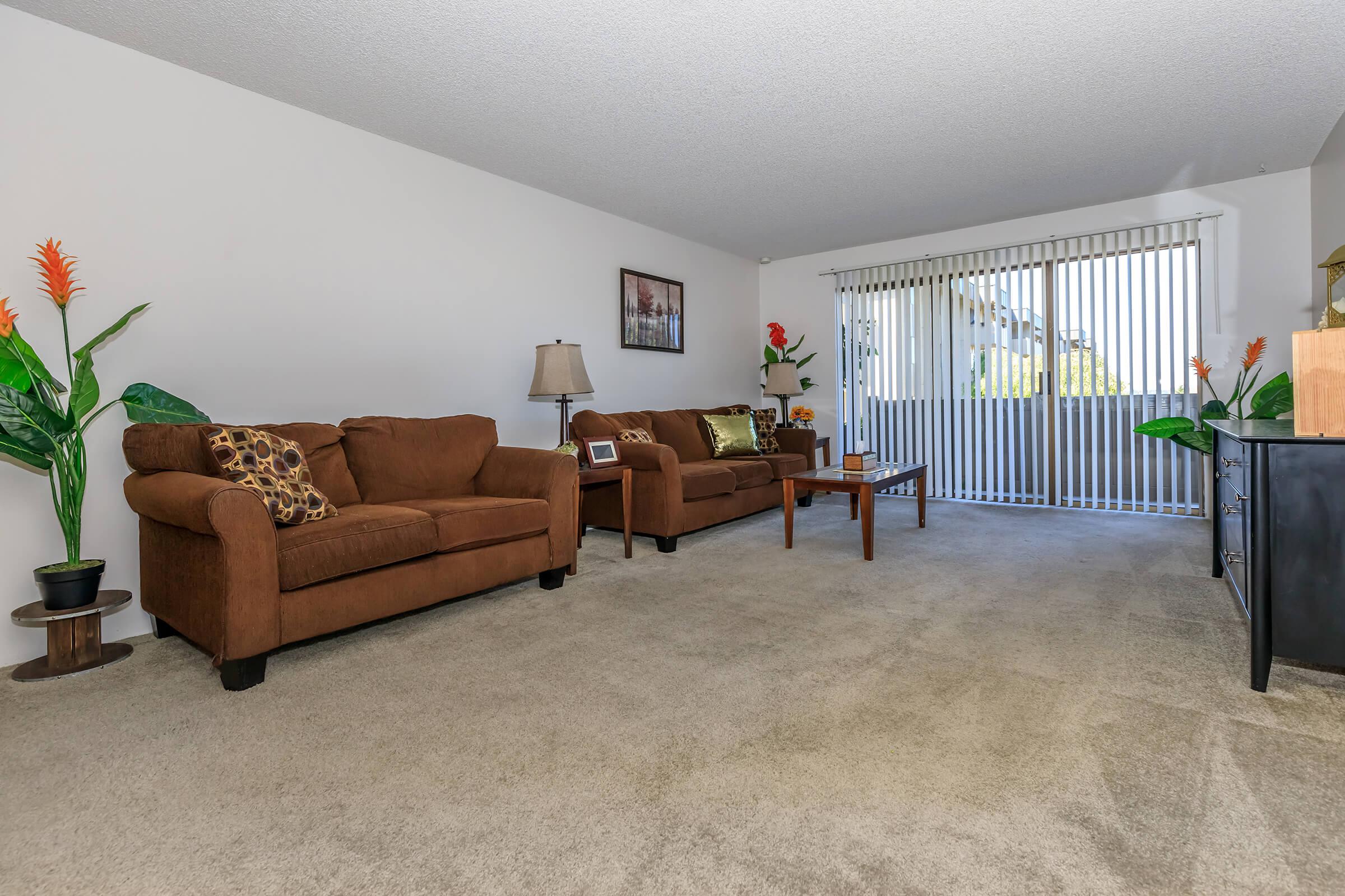 a living room filled with furniture and a flat screen tv