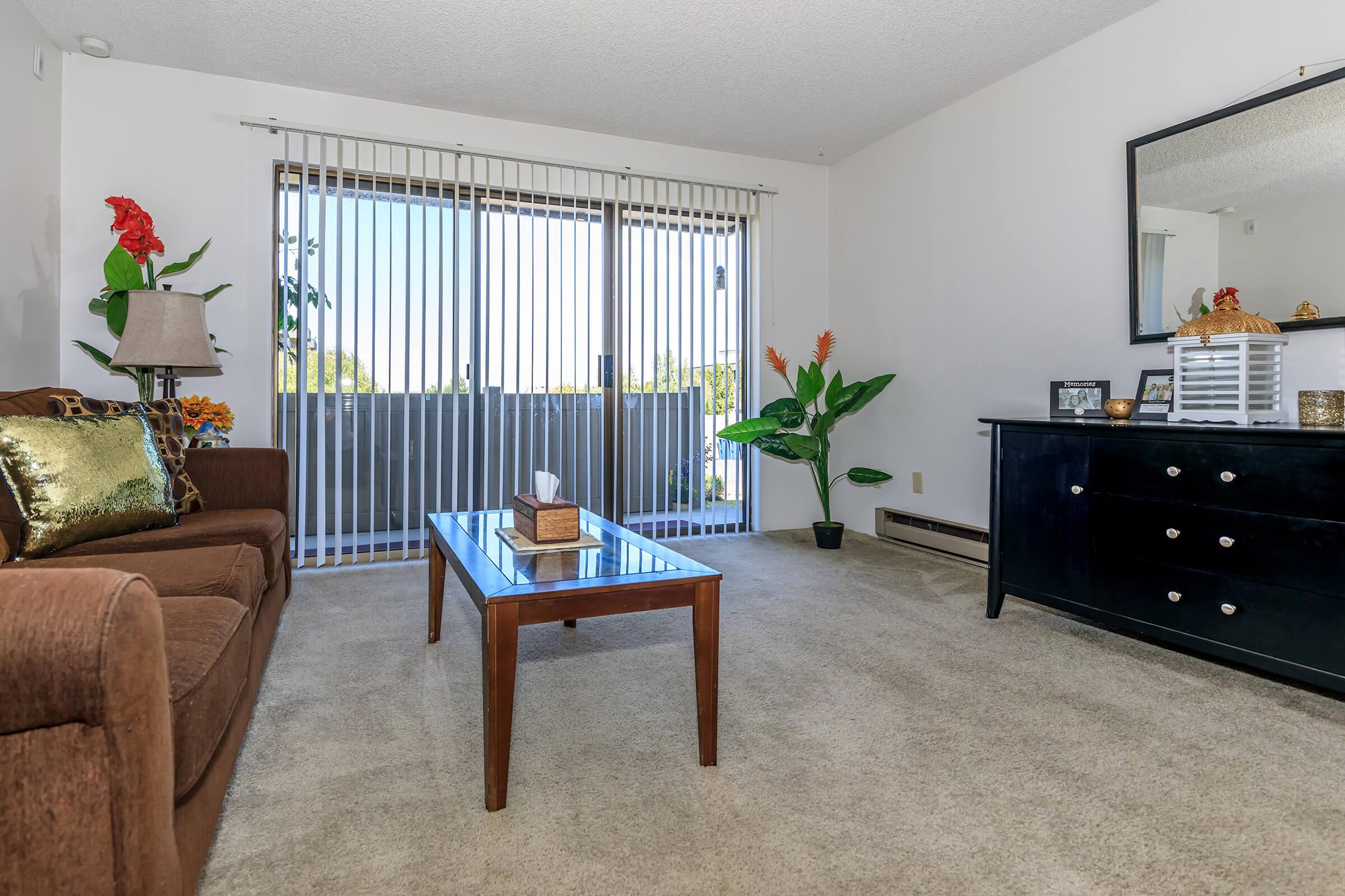 a living room filled with furniture and a flat screen tv