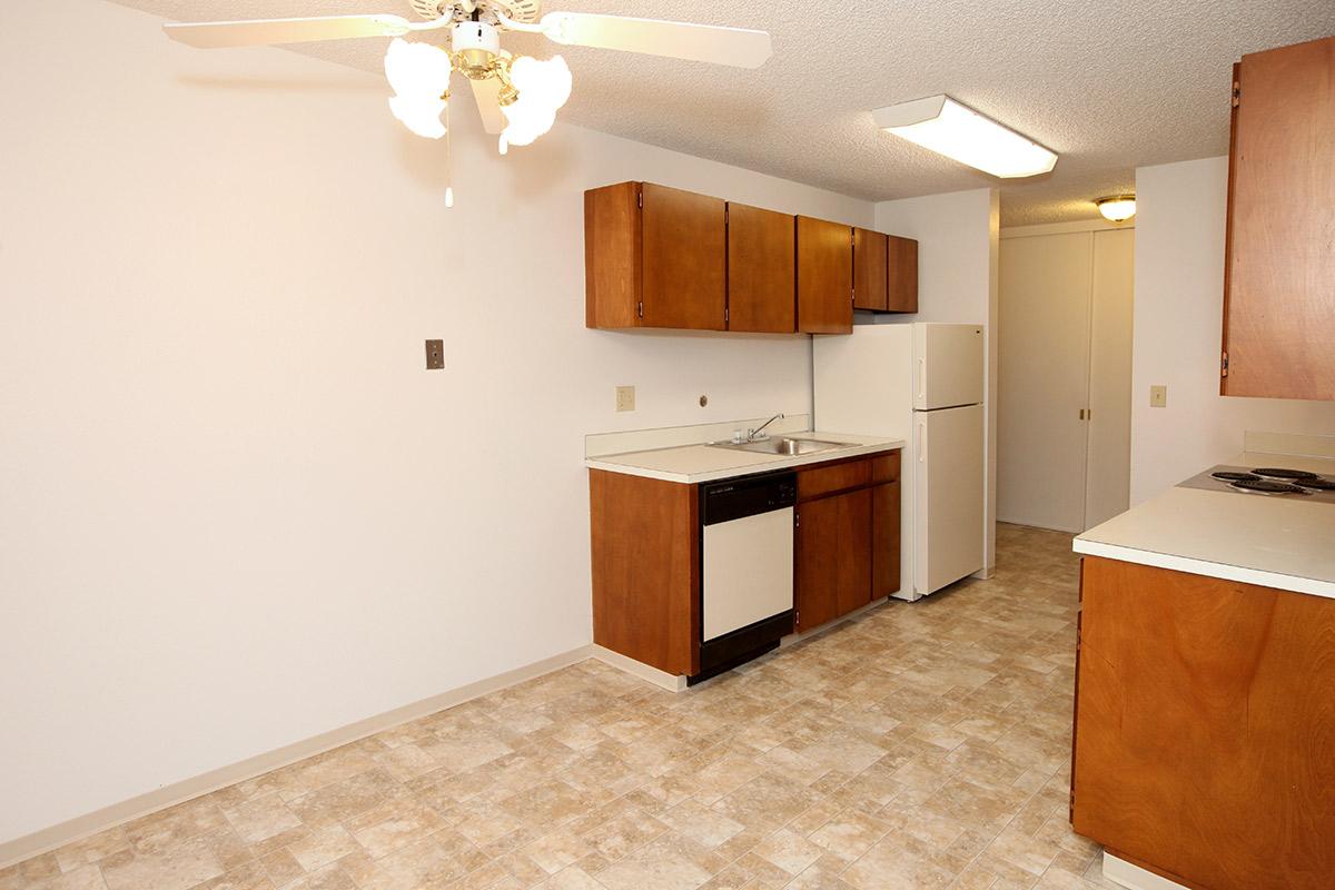 a kitchen with a sink and a refrigerator