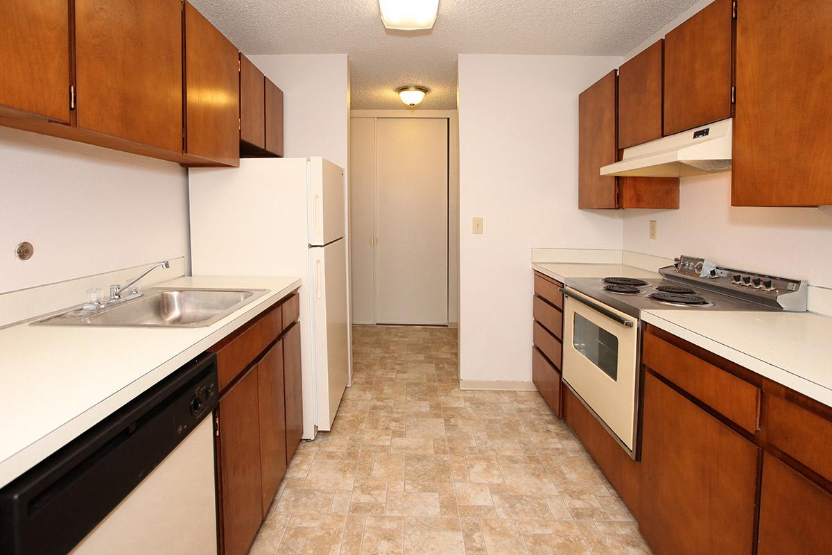 a kitchen with a stove sink and refrigerator