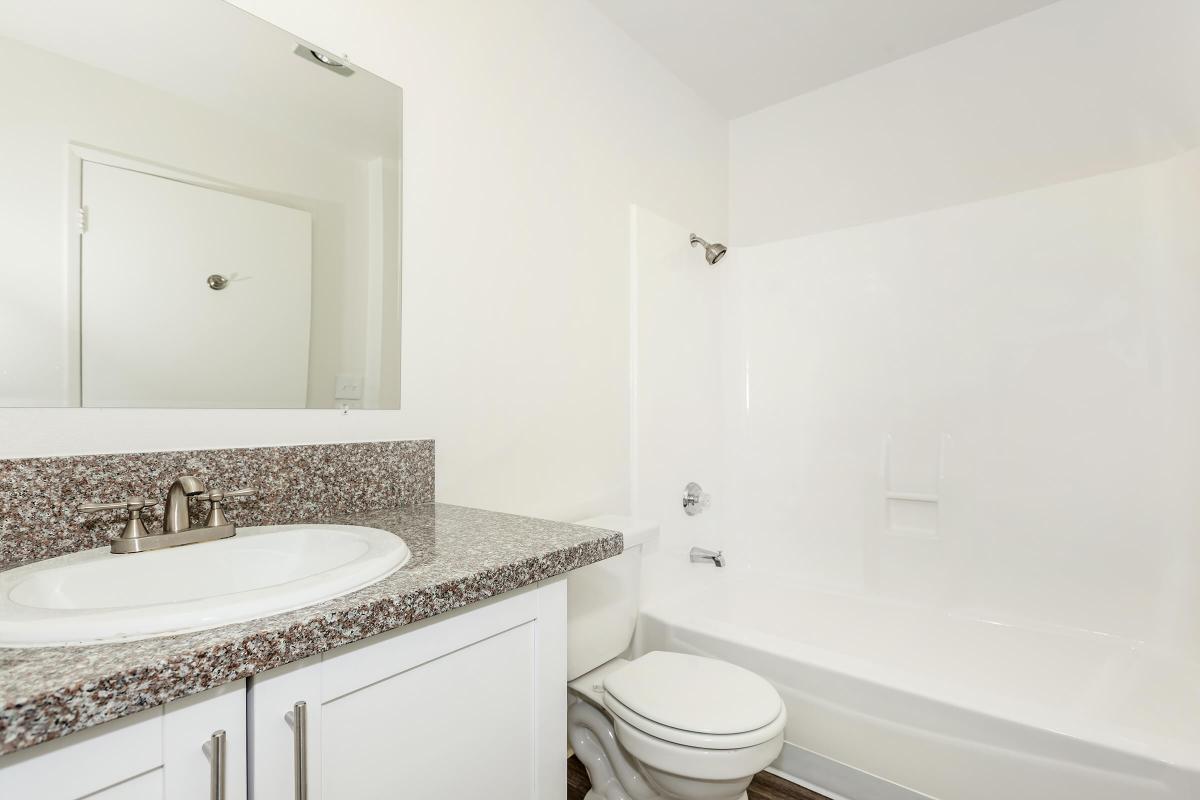 Vacant bathroom with granite countertops