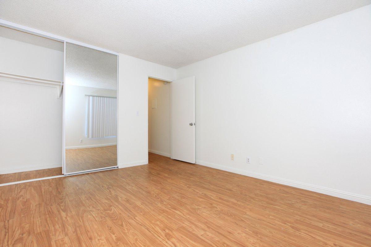Unfurnished bedroom with wooden floors