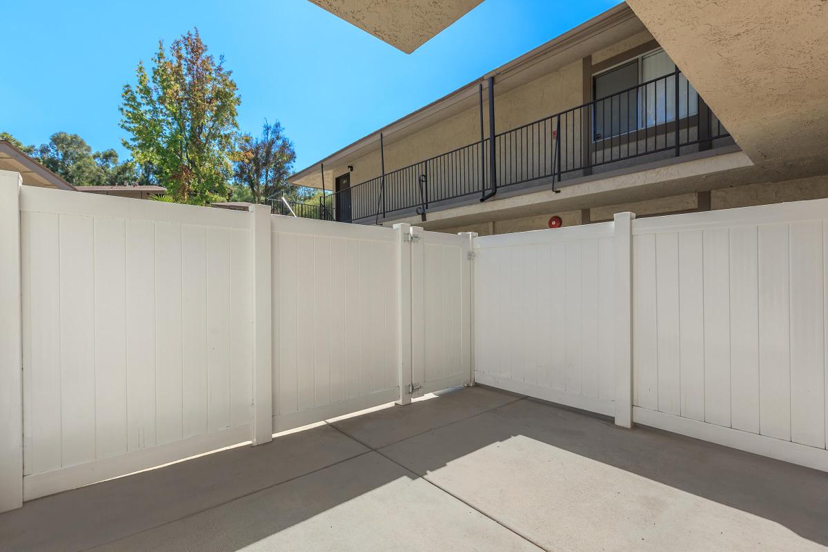 Unfurnished patio with white fencing