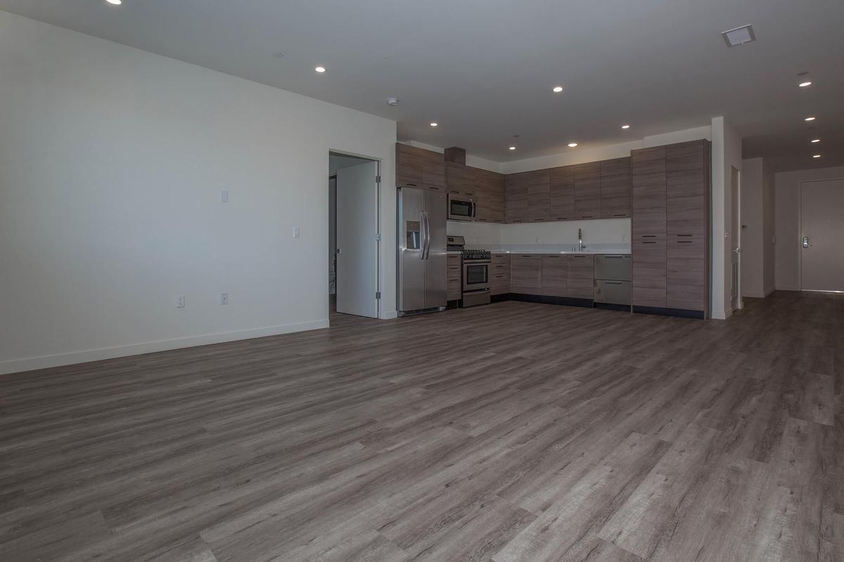a large empty room with a wood floor