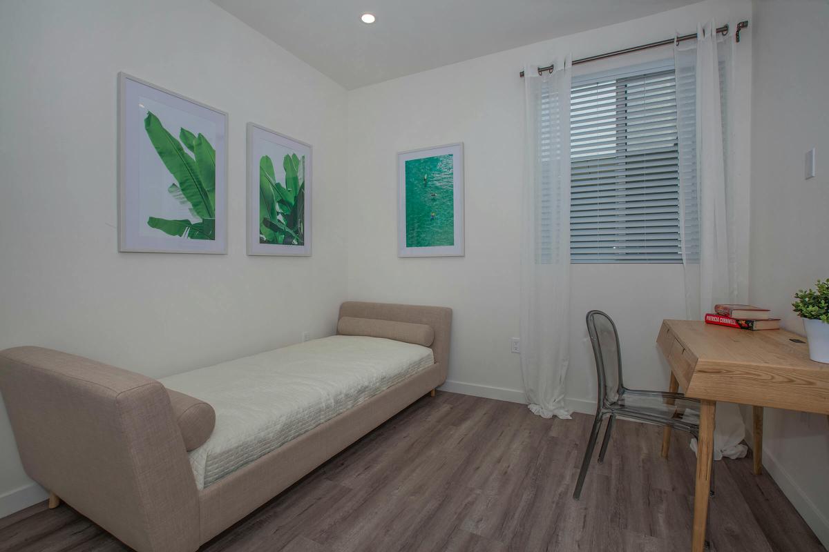 a bedroom with a wooden floor