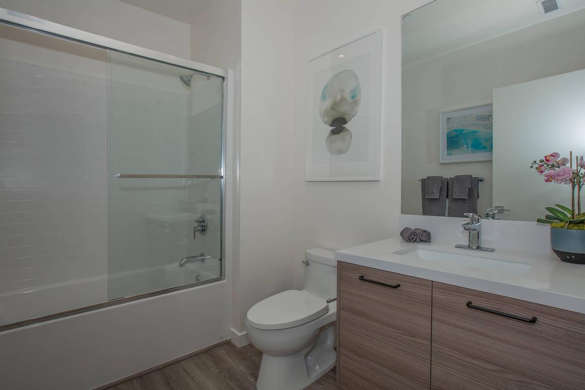 a white tub sitting next to a shower