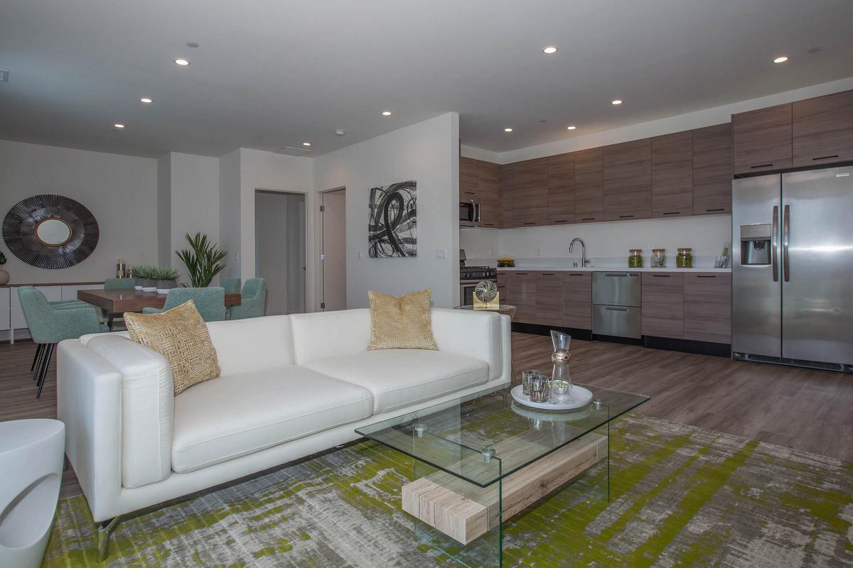 a living room filled with furniture and a large mirror