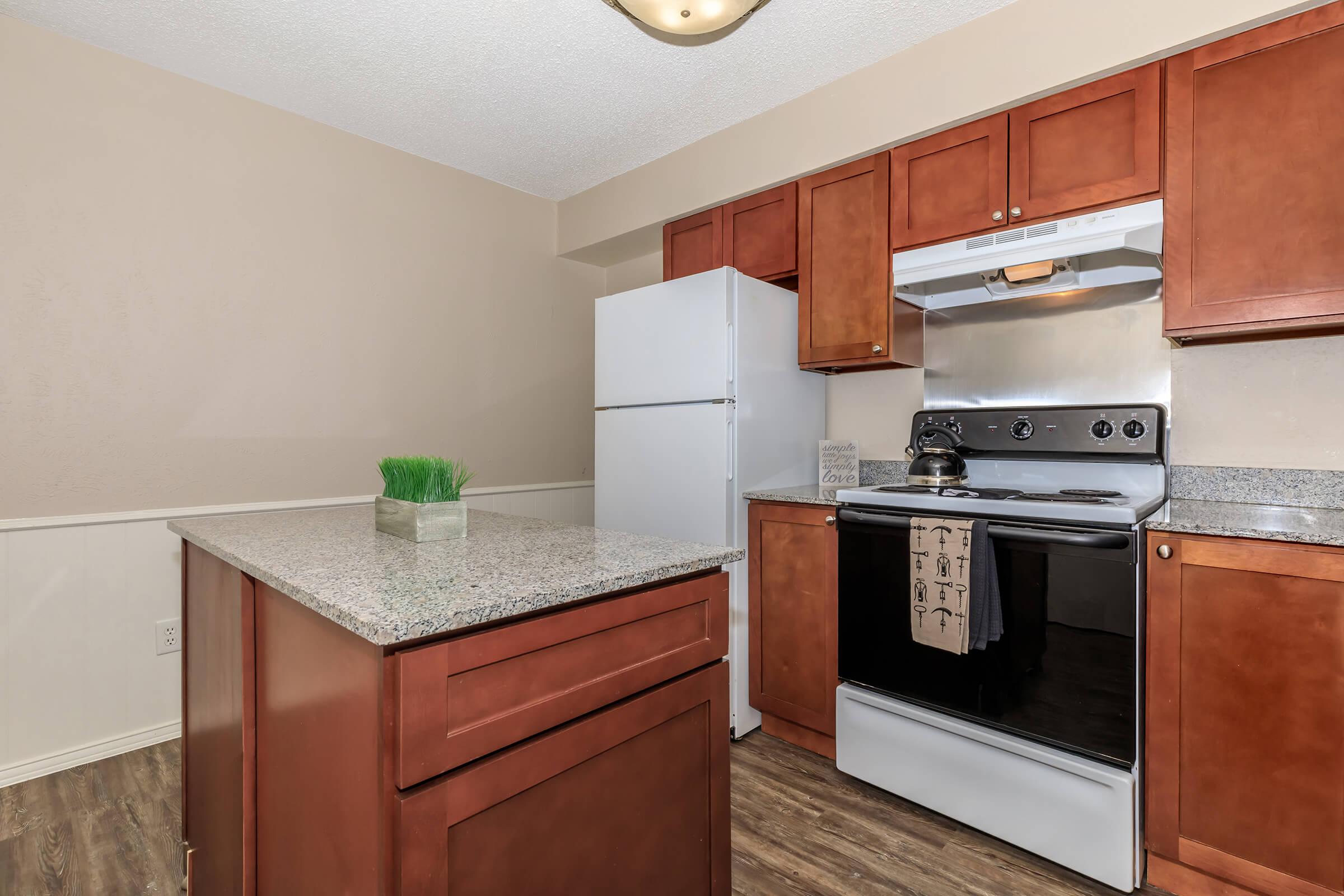 a kitchen with stainless steel appliances and wooden cabinets