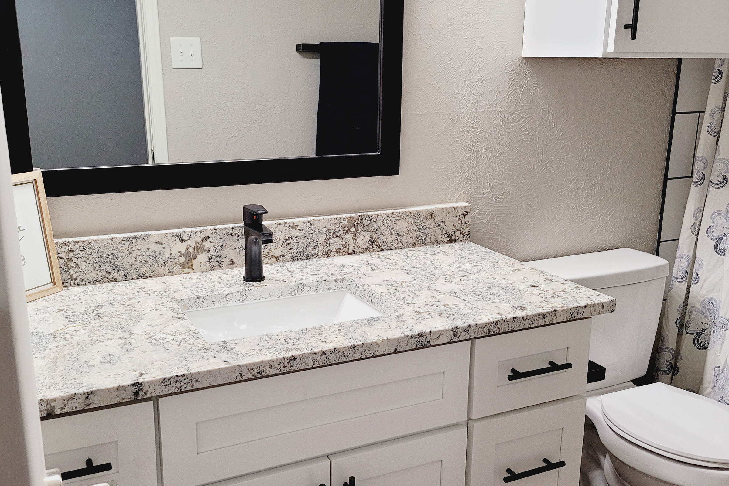 a kitchen with a sink and a mirror