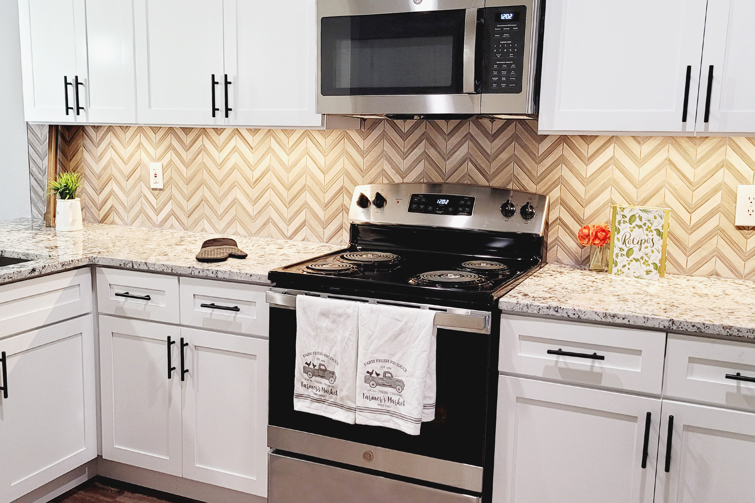 a stove top oven sitting inside of a kitchen