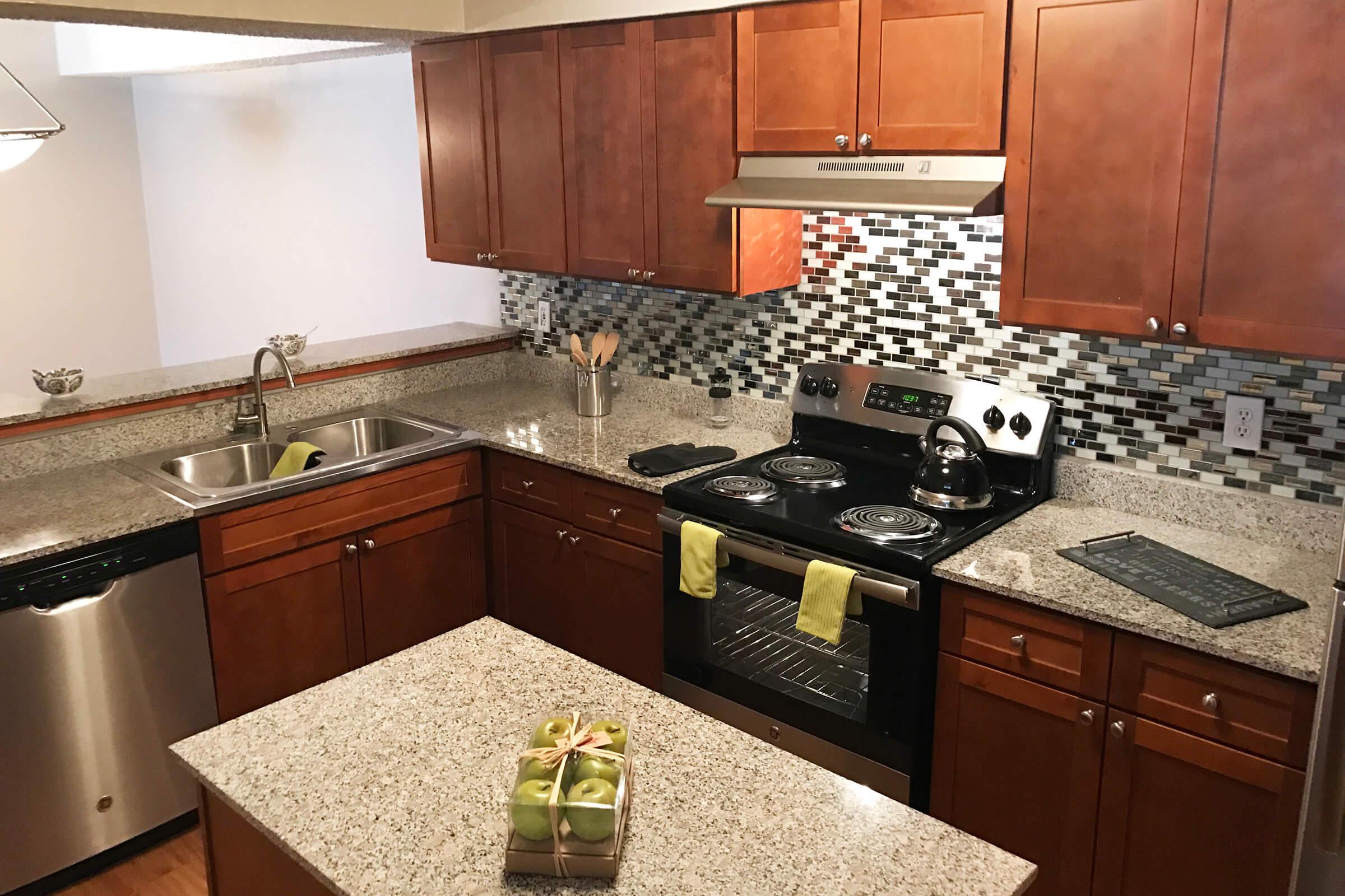 a kitchen with stainless steel appliances and wooden cabinets