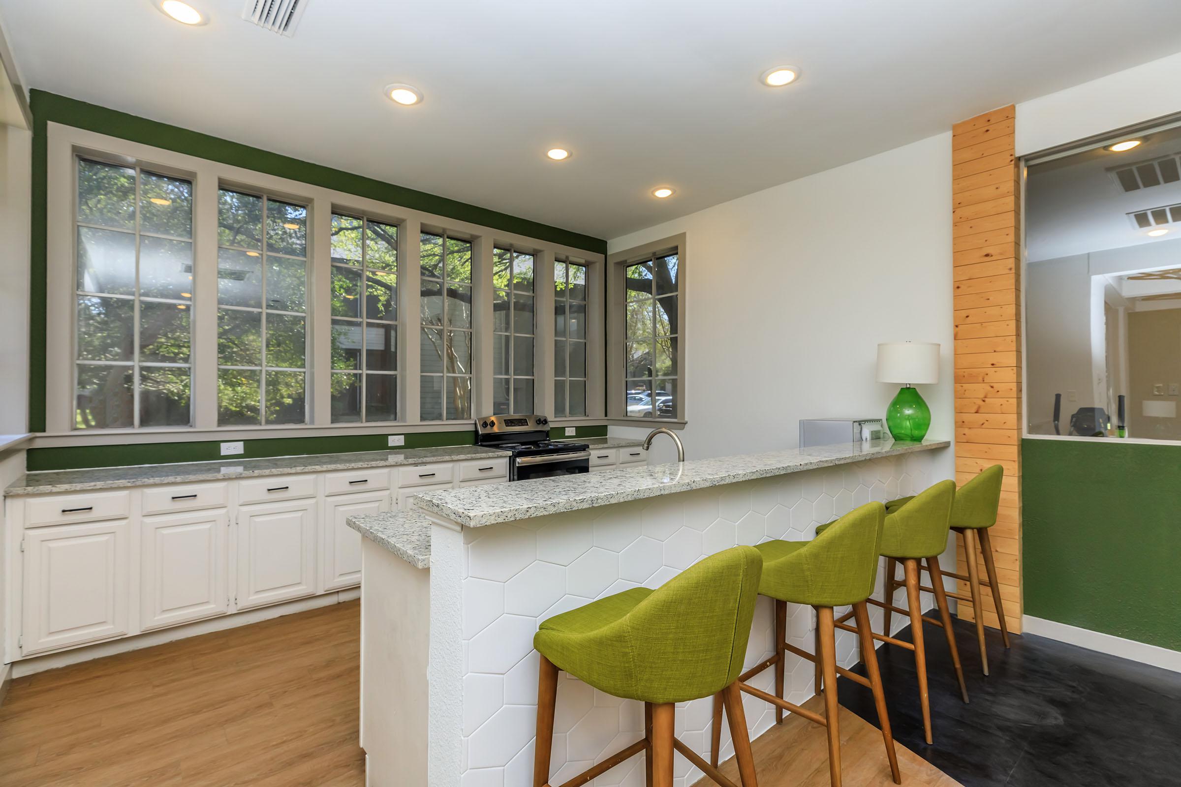 a living room filled with furniture and a large window