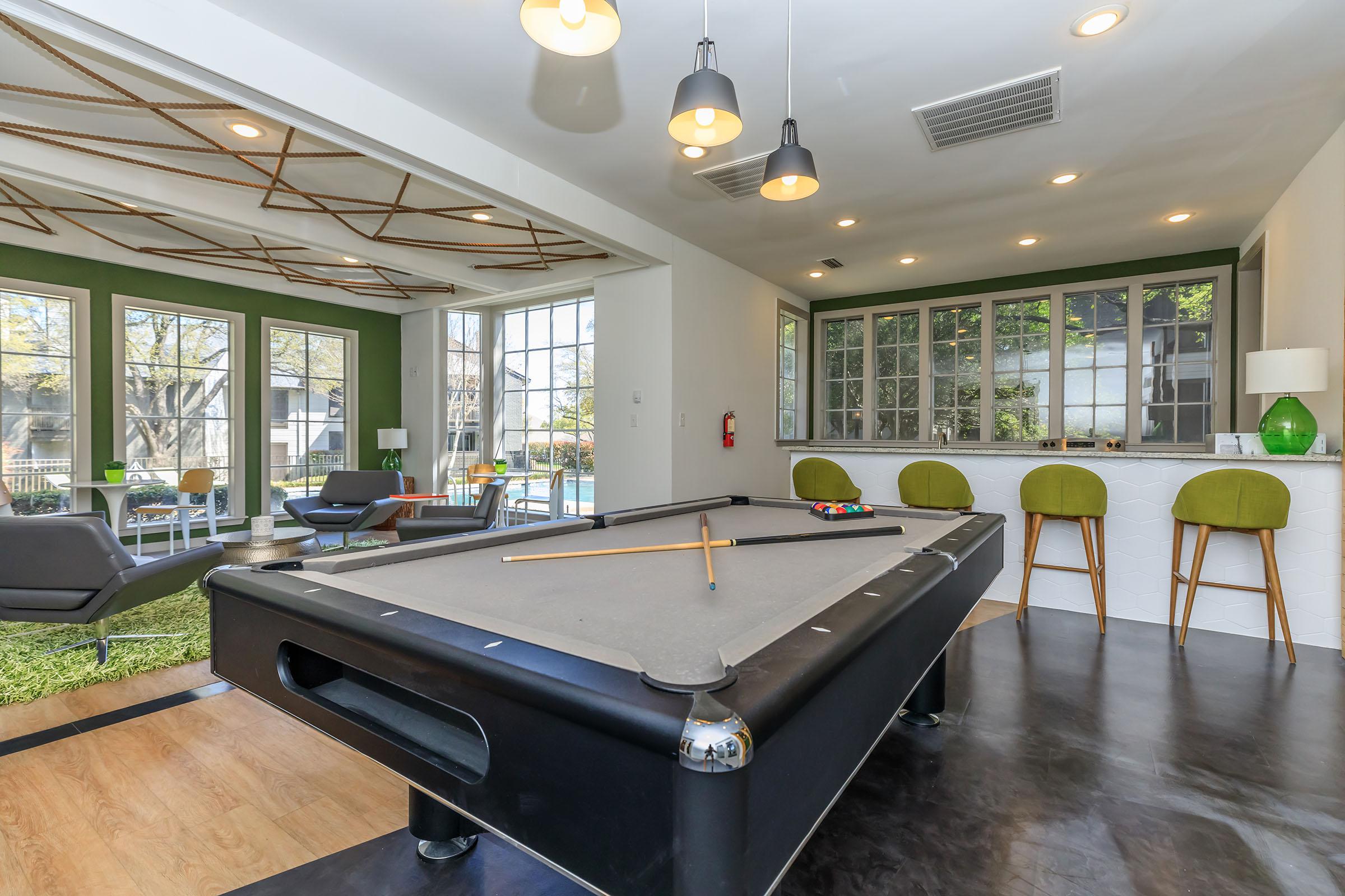 a living room filled with furniture and a large window