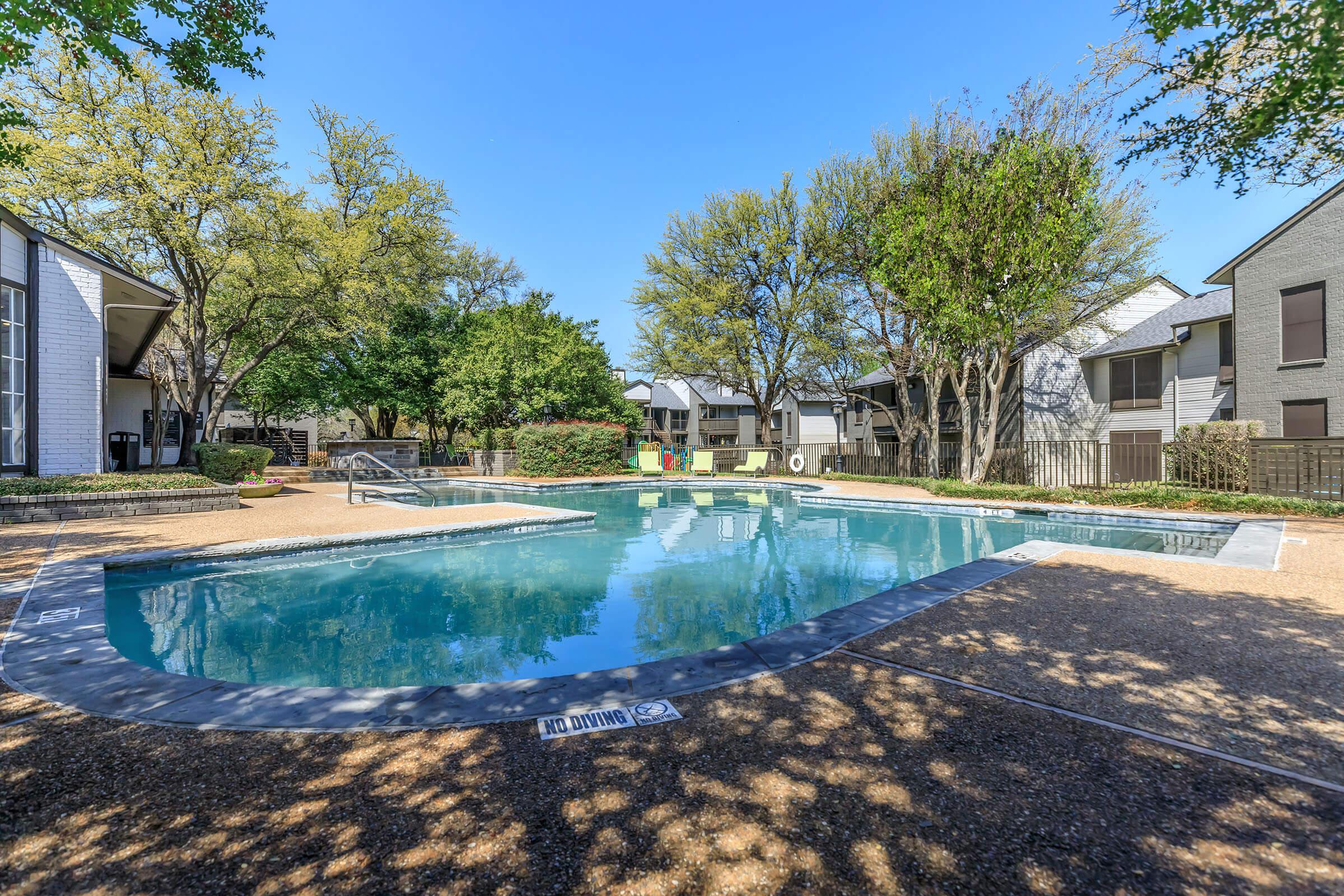 a house with a pool outside of a building